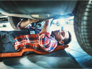 A man works under a car 