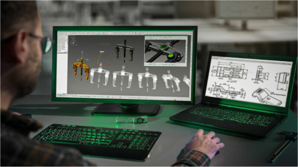 A man sits at the computer and creates tools graphically